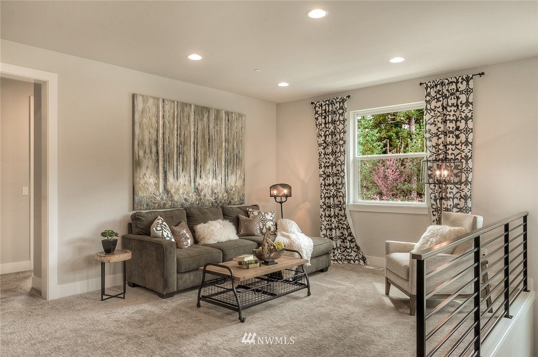 21638 35th Avenue Southeast, Unit 21 Bothell, WA 98021 - Photo 16 of 25 a living room with furniture and a large window