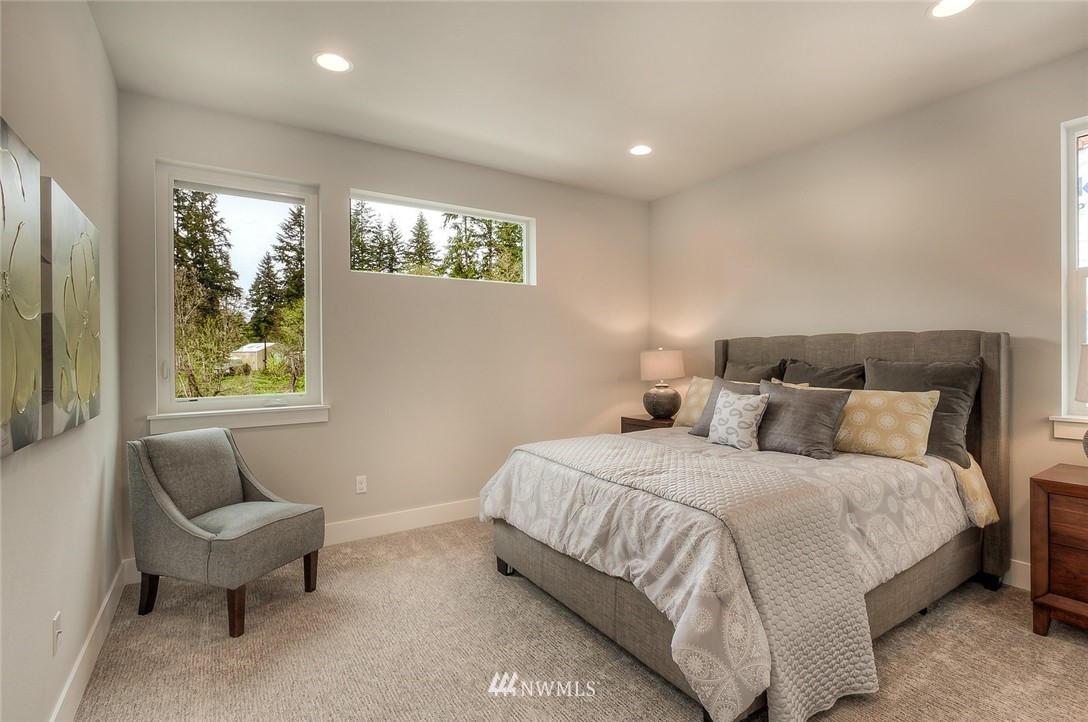 21638 35th Avenue Southeast, Unit 21 Bothell, WA 98021 - Photo 17 of 25 a bedroom with bed and a couch