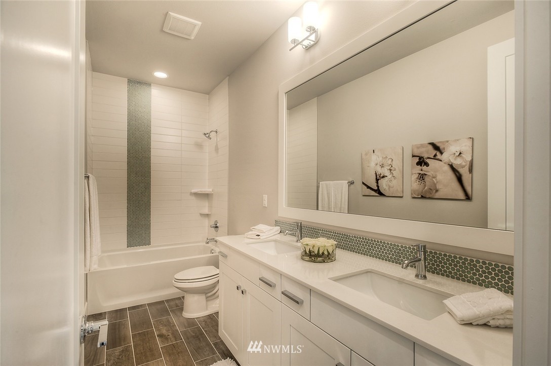 21638 35th Avenue Southeast, Unit 21 Bothell, WA 98021 - Photo 18 of 25 a bathroom with a granite countertop sink toilet and shower