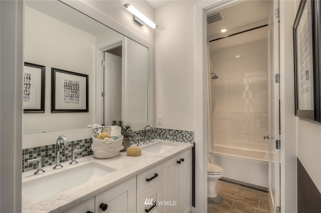 21638 35th Avenue Southeast, Unit 21 Bothell, WA 98021 - Photo 21 of 25 a bathroom with a granite countertop sink and a mirror