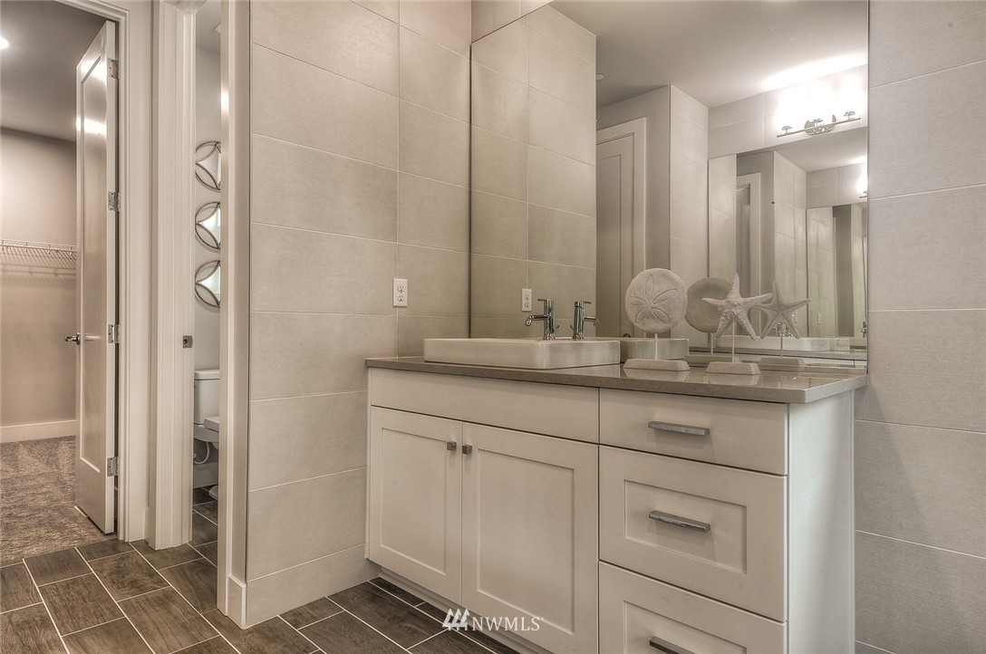 21638 35th Avenue Southeast, Unit 21 Bothell, WA 98021 - Photo 23 of 25 a bathroom with a double vanity sink and a mirror