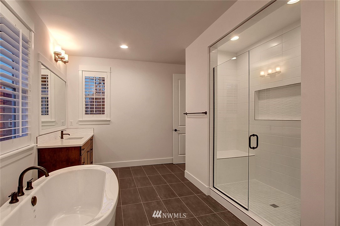 21638 35th Avenue Southeast, Unit 21 Bothell, WA 98021 - Photo 10 of 25 a bathroom with a sink and a mirror