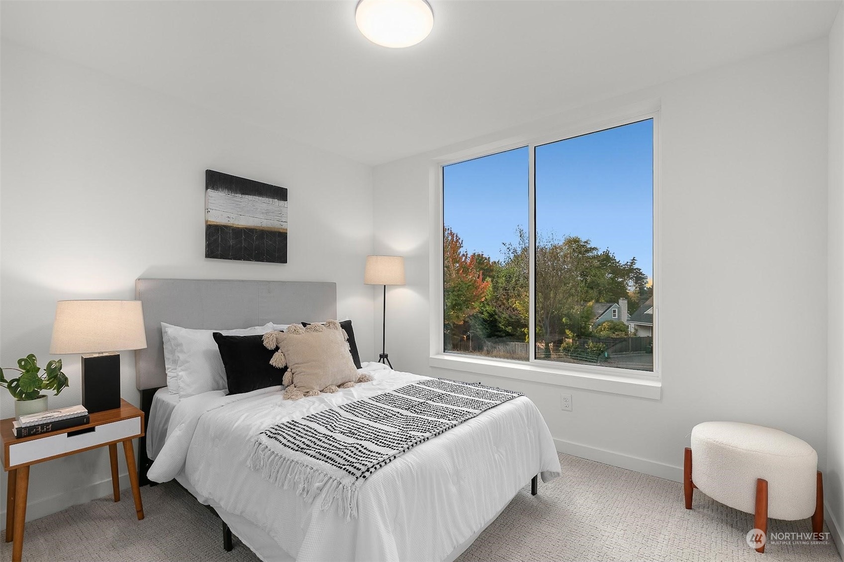10152 Holman Road Northwest Seattle, WA 98133 - Photo 11 of 24 a bedroom with a bed and a lamp