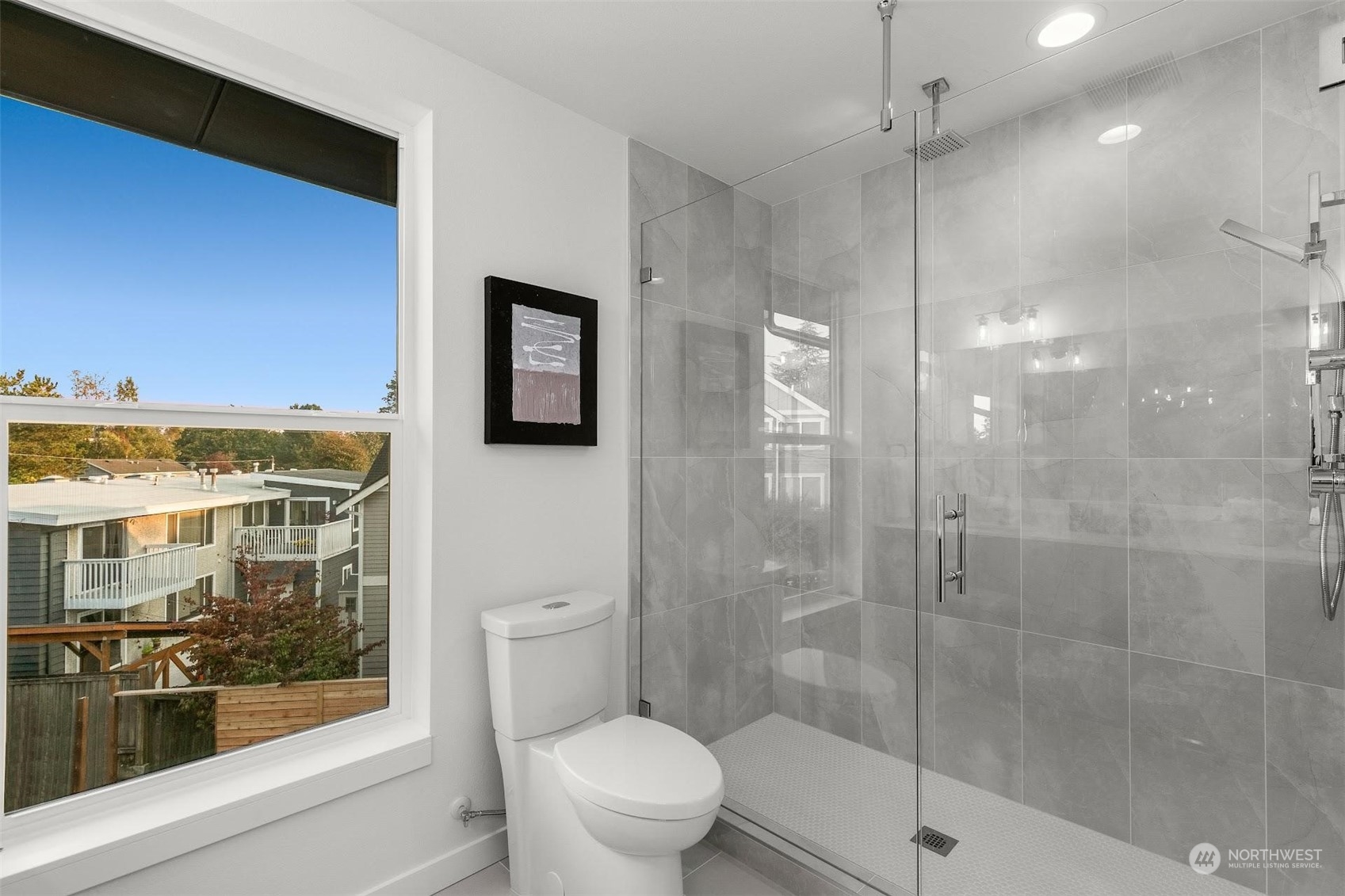 10152 Holman Road Northwest Seattle, WA 98133 - Photo 17 of 24 a bathroom with a glass shower door