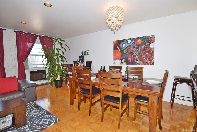 a view of a dining room with furniture wooden floor and a chandelier