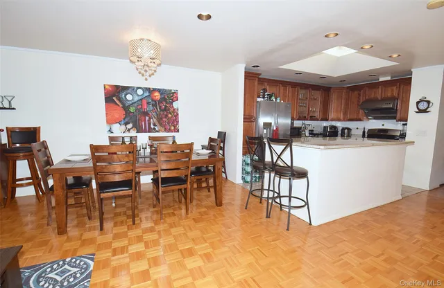 a dining room with furniture a rug and wooden floor
