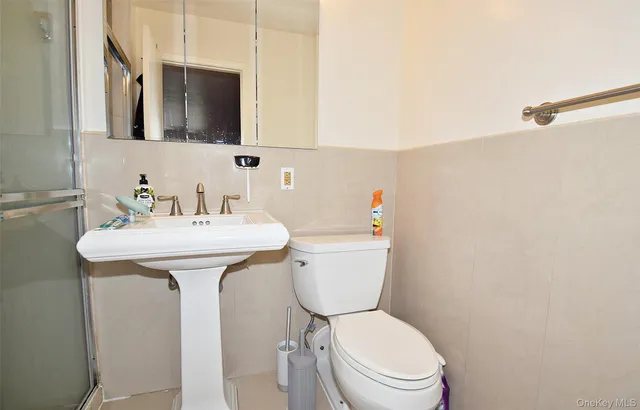 a kitchen with stainless steel appliances granite countertop a refrigerator a sink dishwasher a stove and a sink with wooden cabinets