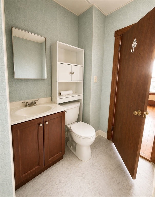 37 Shawmut Street Fall River, MA 02720 - Photo 10 of 16 a bathroom with a toilet a sink a mirror and a shower