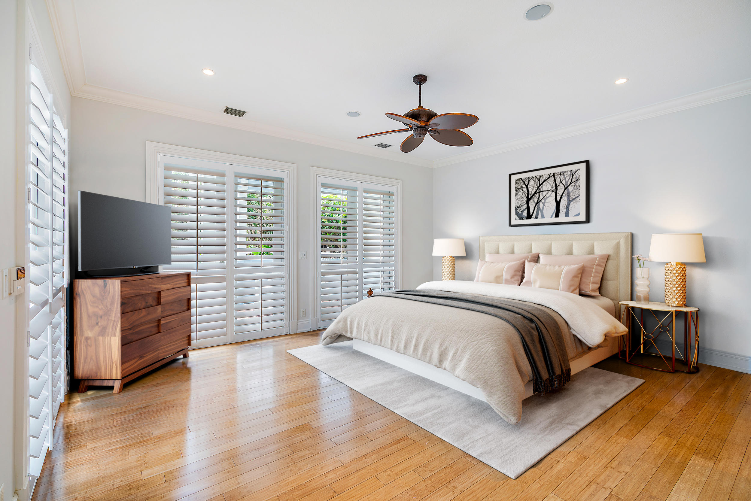 1061 Ocean Drive Juno Beach, FL 33408 - Photo 2 of 3 a spacious bedroom with a bed and a flat screen tv