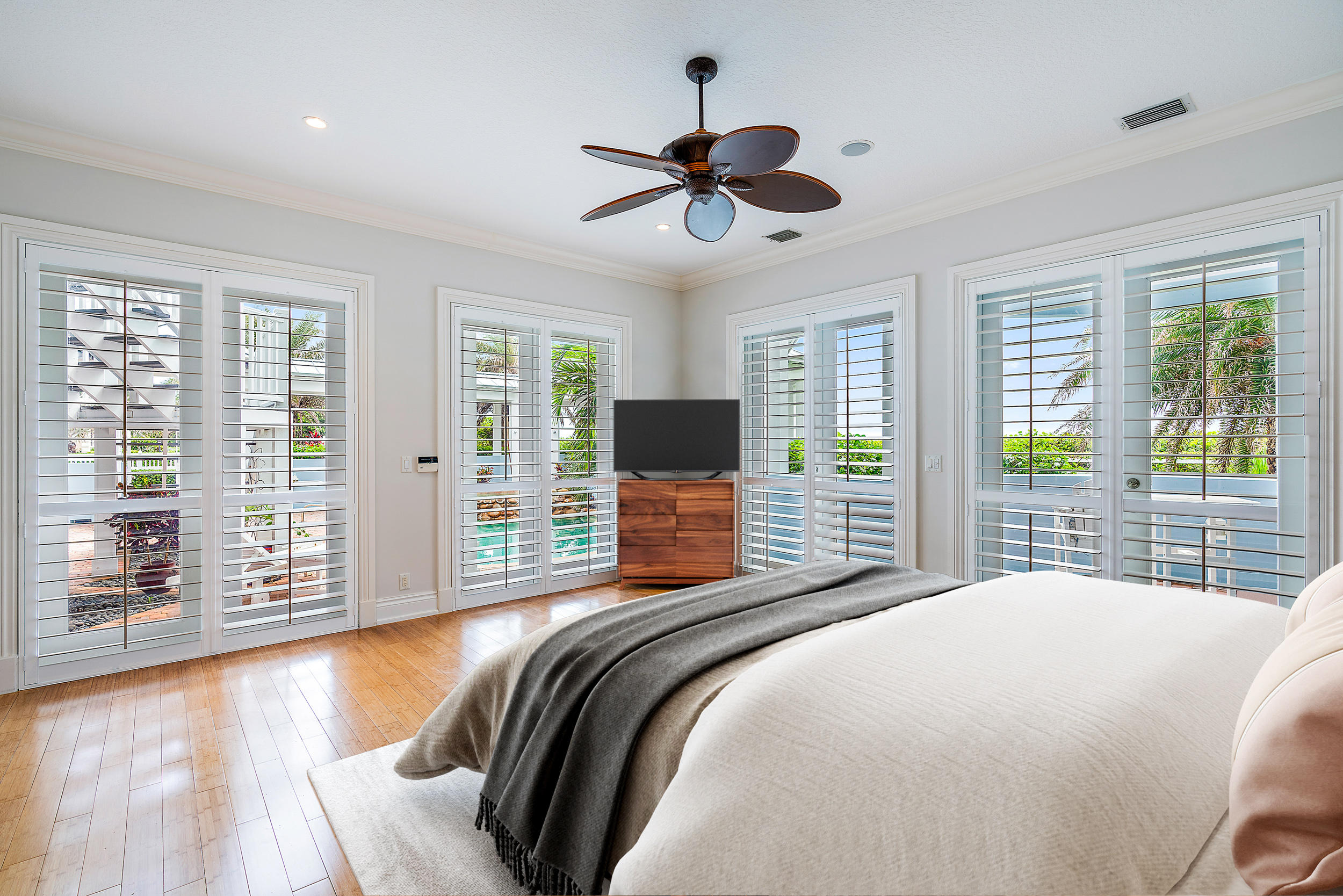 1061 Ocean Drive Juno Beach, FL 33408 - Photo 3 of 3 a bedroom with a large bed and a flat screen tv