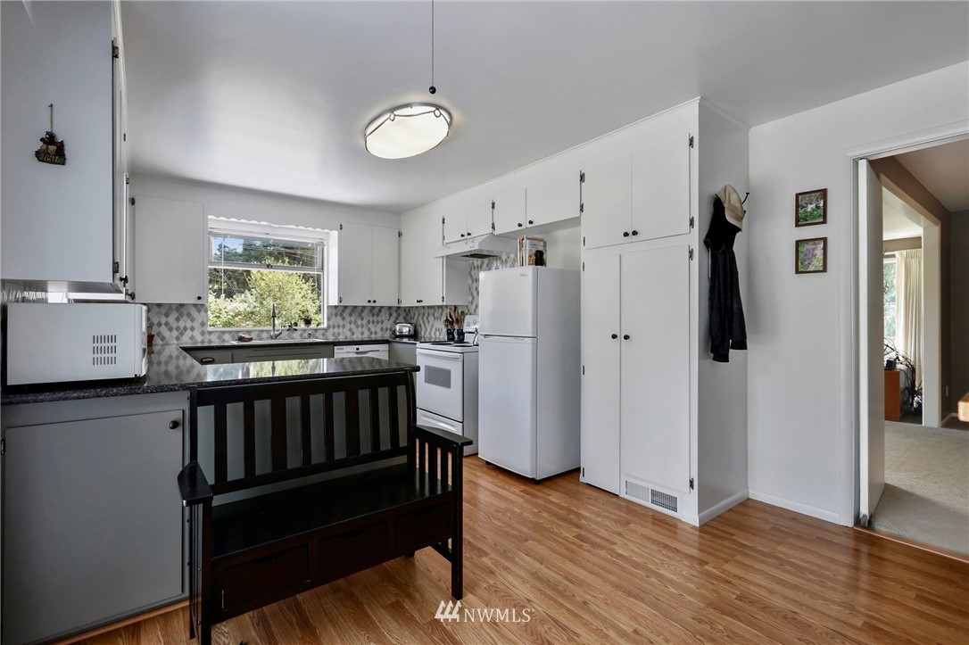 717 224th Street Southwest Bothell, WA 98021 - Photo 12 of 40 a kitchen with stainless steel appliances granite countertop a refrigerator and a stove top oven