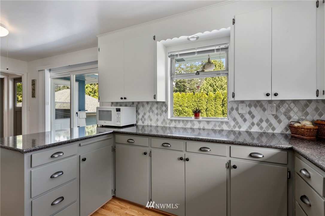 717 224th Street Southwest Bothell, WA 98021 - Photo 15 of 40 a kitchen with appliances cabinets and a window