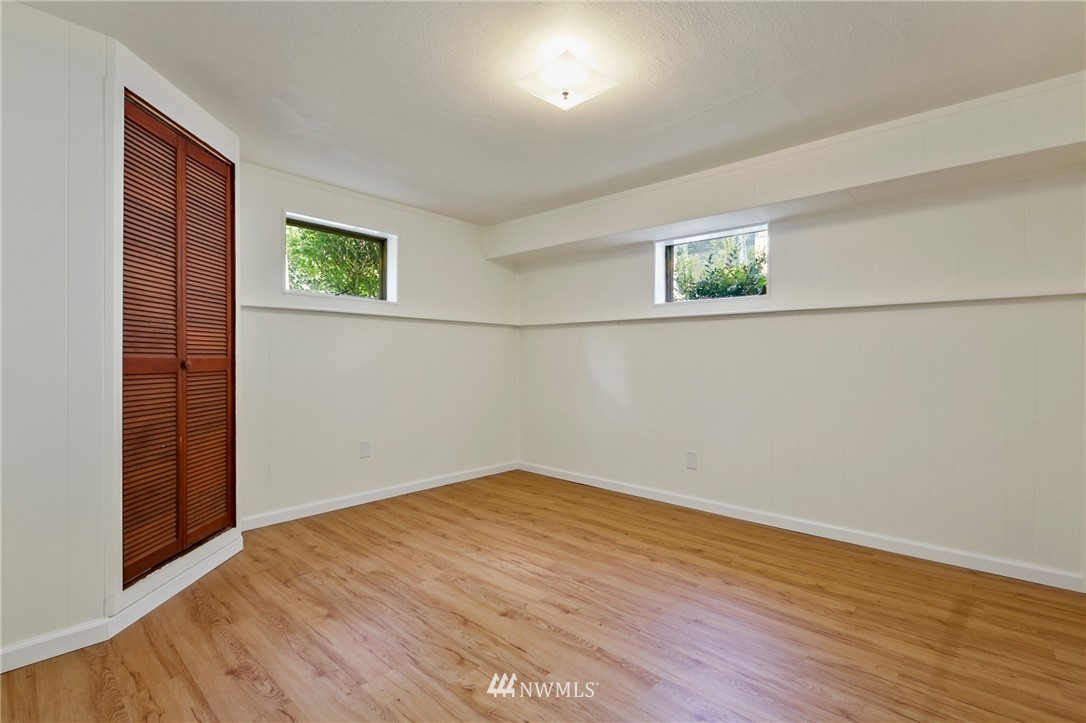 717 224th Street Southwest Bothell, WA 98021 - Photo 28 of 40 an empty room with wooden floor and windows