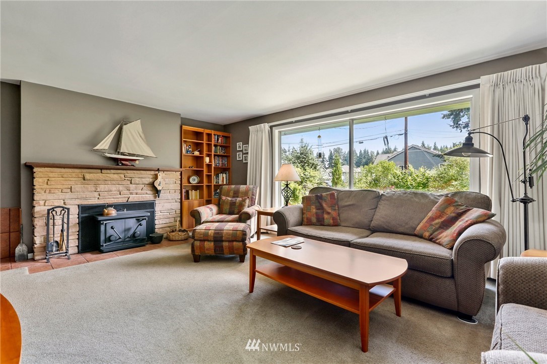 717 224th Street Southwest Bothell, WA 98021 - Photo 5 of 40 a living room with furniture a fireplace and a large window
