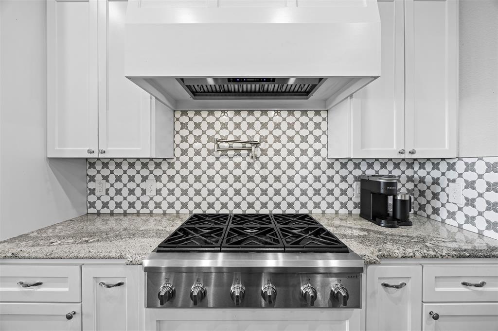 6381 Rigel Road Godley, TX 76044 - Photo 22 of 40 a close view of a stove a microwave and cabinets