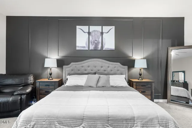 a bedroom with a bed a chandelier and window