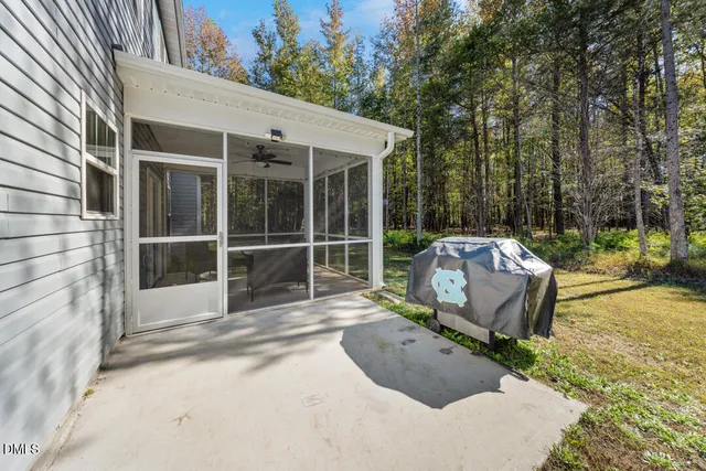 a view of a house with a big yard and large trees