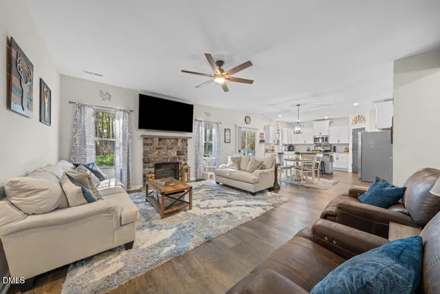a living room with furniture and kitchen view
