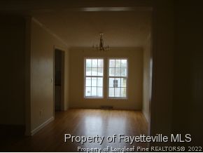 261 Lee Thee Church Road Rockingham, NC 28379 - Photo 3 of 9 an empty room with wooden floor and windows