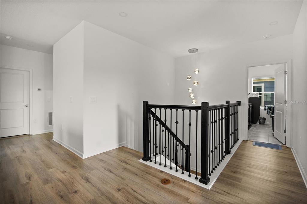11163 Great Rock Street Winter Garden, FL 34787 - Photo 18 of 36 a view of a hallway with wooden floor