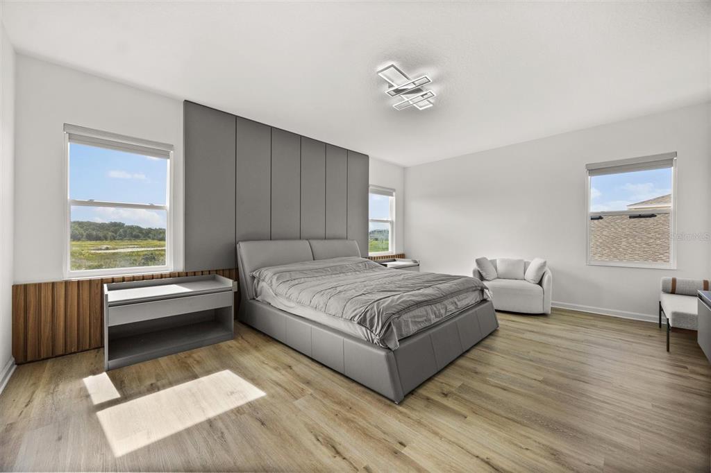 11163 Great Rock Street Winter Garden, FL 34787 - Photo 19 of 36 a spacious bedroom with a bed and a chandelier