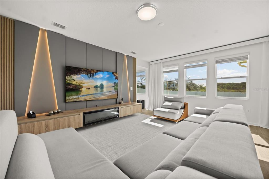 11163 Great Rock Street Winter Garden, FL 34787 - Photo 2 of 36 a living room with furniture and a flat screen tv