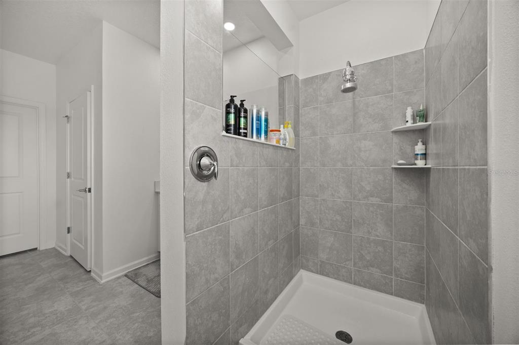 11163 Great Rock Street Winter Garden, FL 34787 - Photo 24 of 36 a bathroom with a shower and a bathtub
