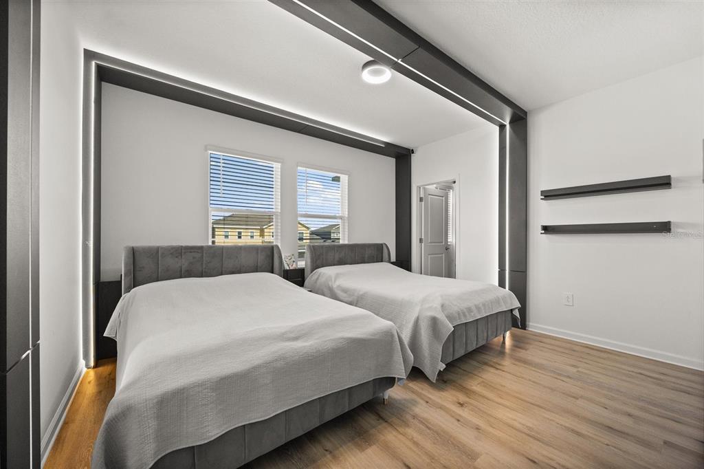 11163 Great Rock Street Winter Garden, FL 34787 - Photo 26 of 36 a bedroom with two beds and a night stand