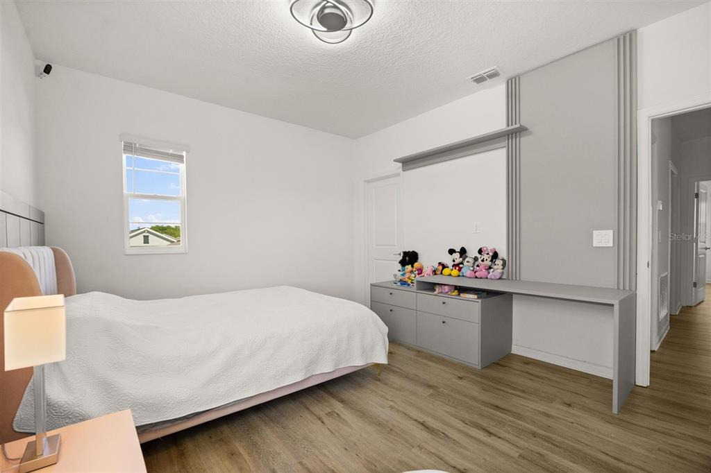 11163 Great Rock Street Winter Garden, FL 34787 - Photo 29 of 36 a bedroom with a bed and a dresser