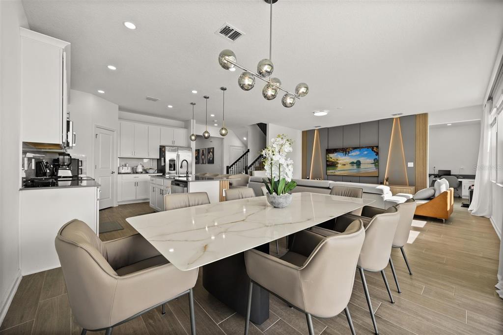 11163 Great Rock Street Winter Garden, FL 34787 - Photo 9 of 36 a view of a dining room and livingroom with furniture wooden floor a chandelier