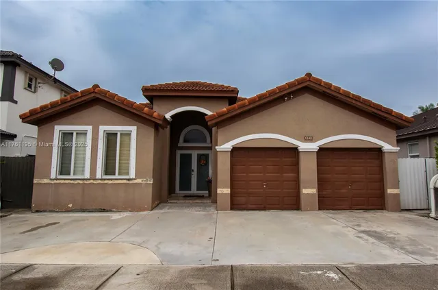 a front view of a house with a garage