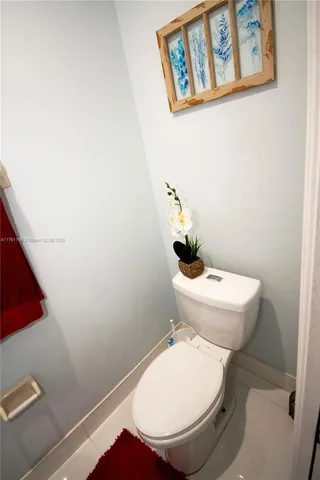 a view of a hallway with wooden floor and a cabinet