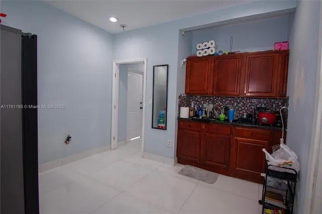 an empty room with a refrigerator and painted wall