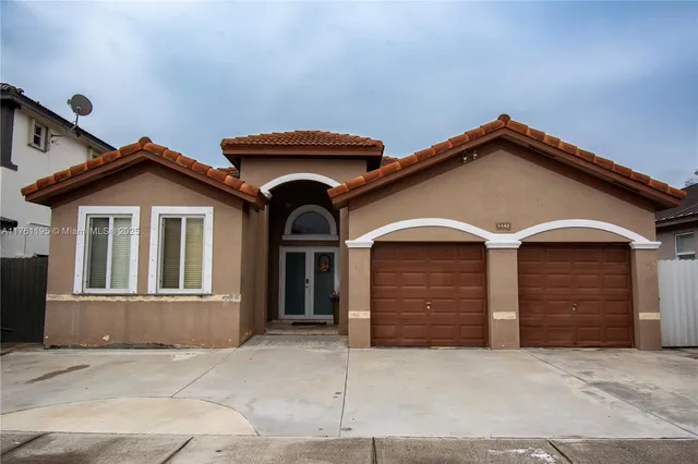 a front view of a house with garage