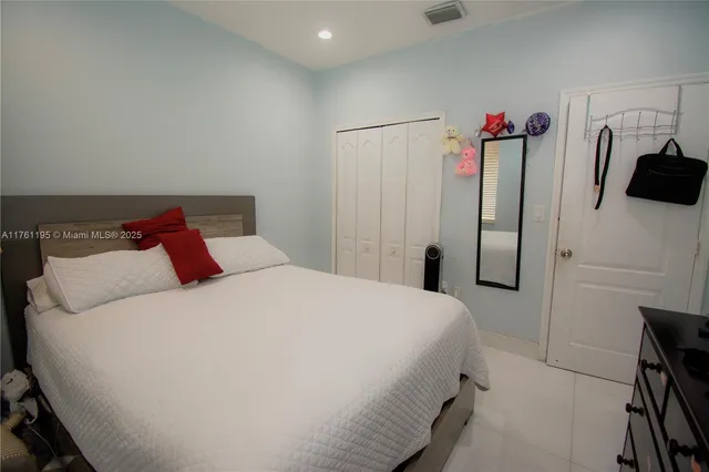 a utility room with wooden floor washer and dryer