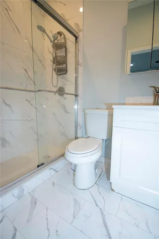 a bathroom with a toilet sink and shower
