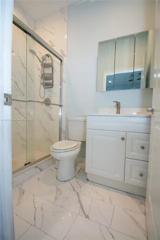 a bedroom with a bed and a mirror