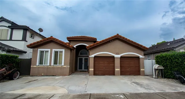 a front view of a house with garage