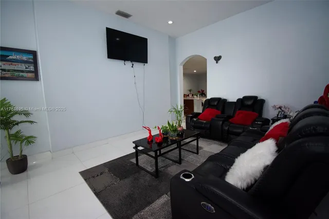 a living room with furniture and a potted plant