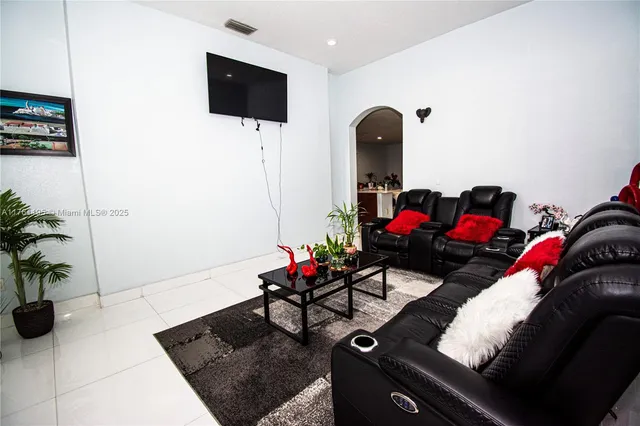 a living room with furniture and a potted plant