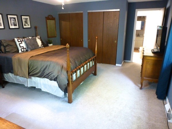 59 Mountain Gate Road, Unit 59 Ashland, MA 01721 - Photo 19 of 25 a bed sitting in a bedroom next to a window
