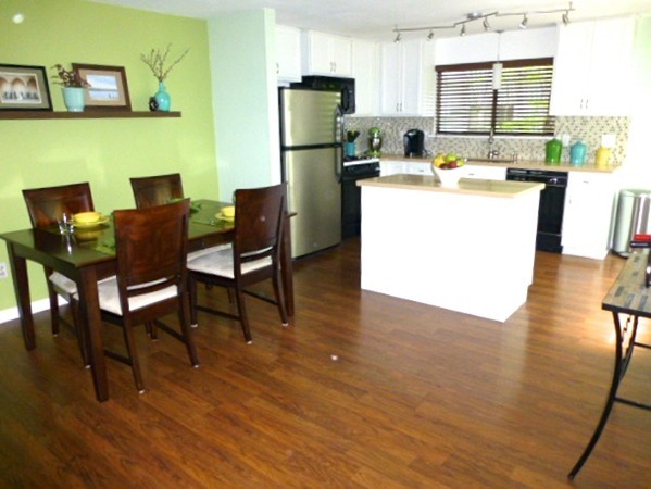 59 Mountain Gate Road, Unit 59 Ashland, MA 01721 - Photo 4 of 25 a kitchen with a table chairs refrigerator and a window