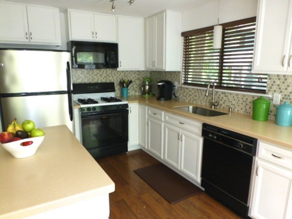 59 Mountain Gate Road, Unit 59 Ashland, MA 01721 - Photo 6 of 25 a kitchen with a sink a stove and cabinets