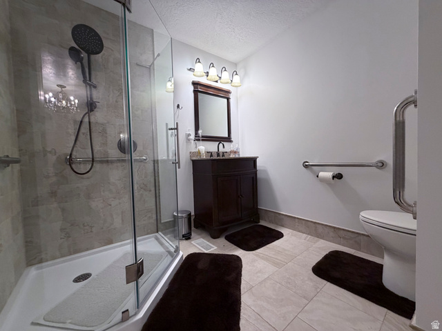 2855 South 1000 West Perry, UT 84302 - Photo 120 of 142 Bathroom with vanity, a textured ceiling, and a shower stall