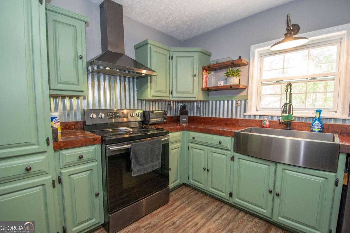 3414 Rock Mills Road LaGrange, GA 30240 - Photo 14 of 54 a kitchen with lots of counter top space and a sink