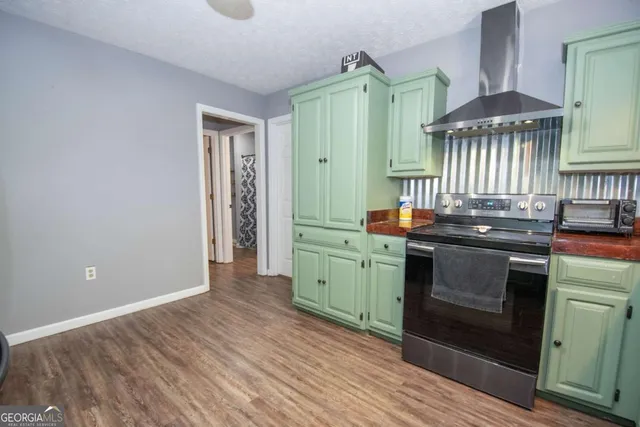 a kitchen with lots of counter top space sink and stainless steel appliances