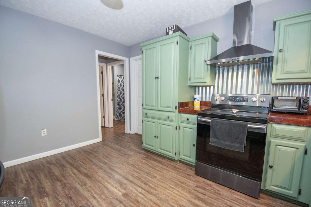 3414 Rock Mills Road LaGrange, GA 30240 - Photo 15 of 54 a kitchen with stainless steel appliances granite countertop a stove a sink and a refrigerator