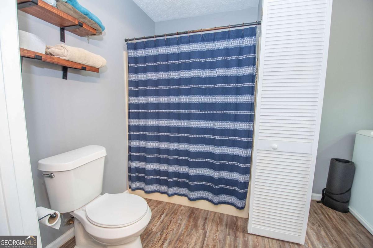 3414 Rock Mills Road LaGrange, GA 30240 - Photo 22 of 54 a white toilet sitting next to a white cabinet