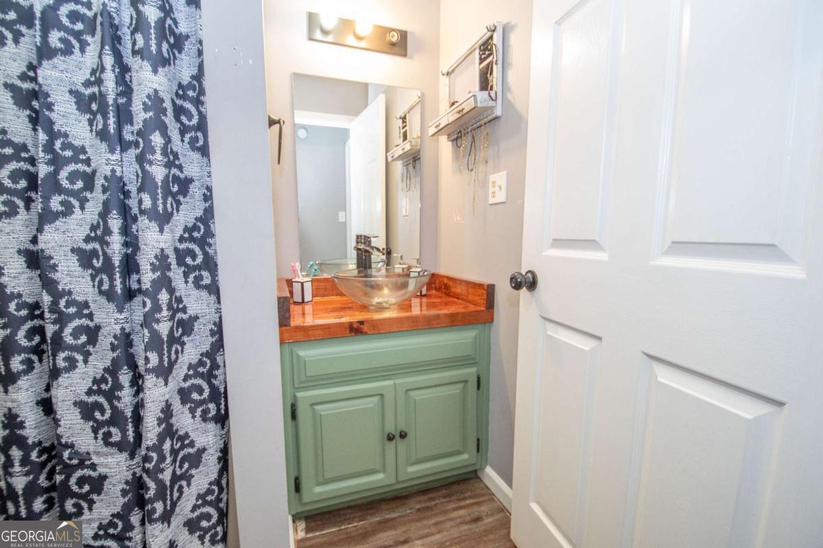 3414 Rock Mills Road LaGrange, GA 30240 - Photo 26 of 54 a bathroom with a sink and a mirror