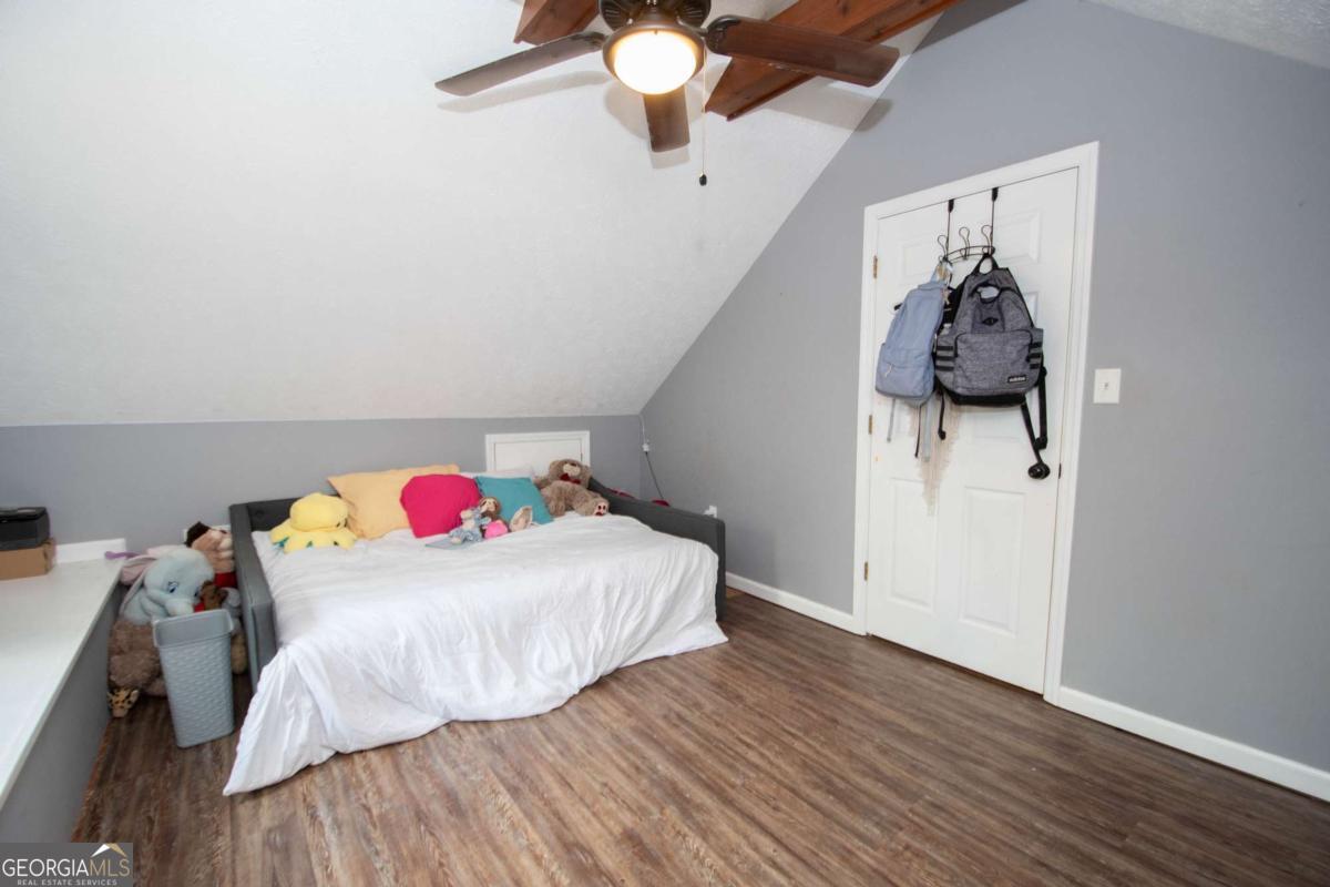 3414 Rock Mills Road LaGrange, GA 30240 - Photo 31 of 54 a bedroom with a bed and a chandelier